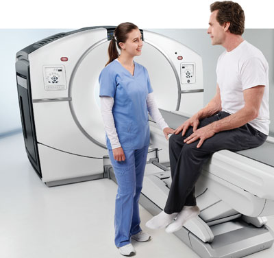 Technologist helping patient have PET Scan